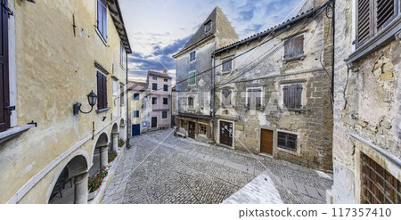 Picture from the town of Groznjan with idyllic cobbled streets and buildings made of natural stone Picture from the town of Groznjan with idyllic cobbled streets and buildings made of natural stone 117357410