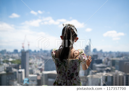 girl looking out the window girl looking out the window 117357700