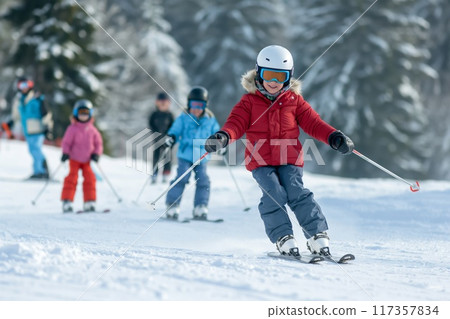 Multi-generation family members of diverse backgrounds enjoy a winter day skiing together in the mountains Multi-generation family members of diverse backgrounds enjoy a winter day skiing together in the mountains 117357834
