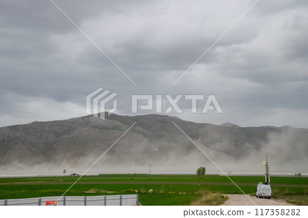 puffs of steam from hot spring near the mountains puffs of steam from hot spring near the mountains 117358282