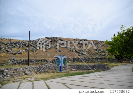 Huge blocks of a wall destroyed by an earthquake. Ruins of the city of Hierapolis 117358682