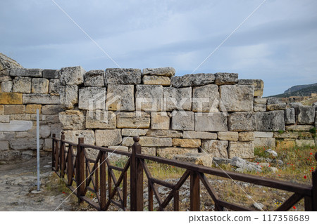 walls of the ancient ruins of limestone blocks. Ruins of the city of Hierapolis, Turkey. walls of the ancient ruins of limestone blocks. Ruins of the city of Hierapolis, Turkey. 117358689
