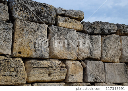 walls of the ancient ruins of limestone blocks. Ruins of the city of Hierapolis, Turkey. 117358691