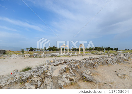 Elements of antique ruins of limestone blocks. The destroyed columns. Ruins of city of Hierapolis 117358694