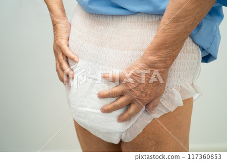 Asian elderly woman wearing diaper for loss of bladder urinary incontinence control. 117360853