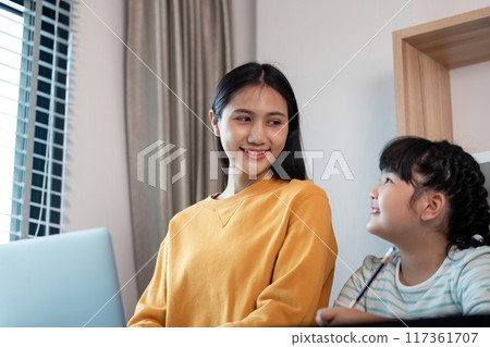 Loving Mother and Daughter Bonding at Home, Smiling and Enjoying Quality Time Together in a Modern Living Room 117361707