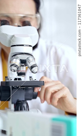 Woman scientist using microscope in laboratory. Microbiology science concept Woman scientist using microscope in laboratory. Microbiology science concept 117361847