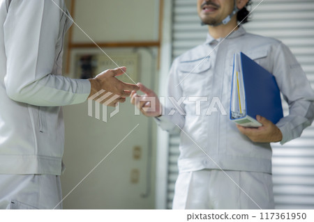 A man in work clothes checking the site 117361950