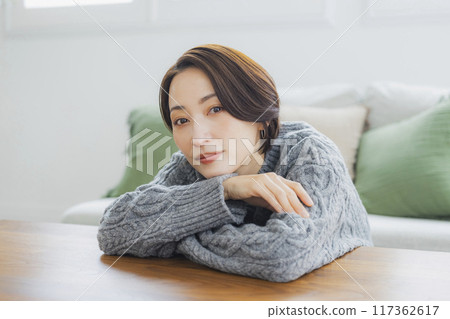 A knitted woman relaxing in her room 117362617