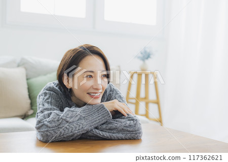 A knitted woman relaxing in her room A knitted woman relaxing in her room 117362621