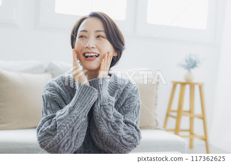A knitted woman relaxing in her room A knitted woman relaxing in her room 117362625