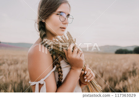 Woman in Wheat Field with a Bouquet of Wheat 117363029