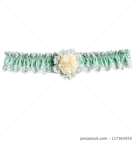 Pastel green lace garter with rosette detail floating upwards delicate and detailed isolated Pastel green lace garter with rosette detail floating upwards delicate and detailed isolated 117363059