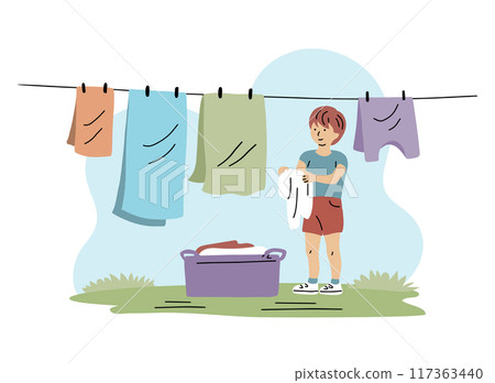 Little boy hanging out laundry after washing Little boy hanging out laundry after washing 117363440