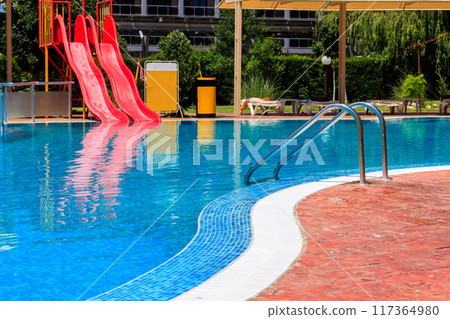 Swimming pool with water slide at the tropic summer resort 117364980