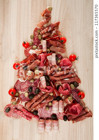 Christmas tree made of sausage on a background of a wooden wall Christmas tree made of sausage on a background of a wooden wall 117365570