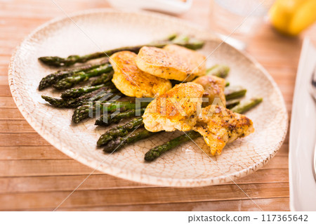 Dietary meal rich in protein. Stir fried chicken breast and green asparagus 117365642