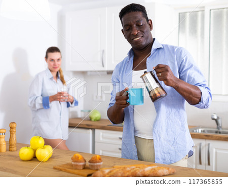 Husband and wife having breakfast together at home 117365855
