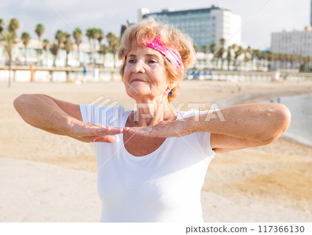 Mature woman training on beach 117366130
