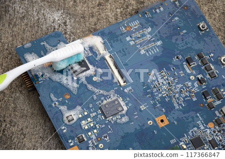 Top view. Technician cleaning motherboard. computer with cleaning solution Top view. Technician cleaning motherboard. computer with cleaning solution 117366847