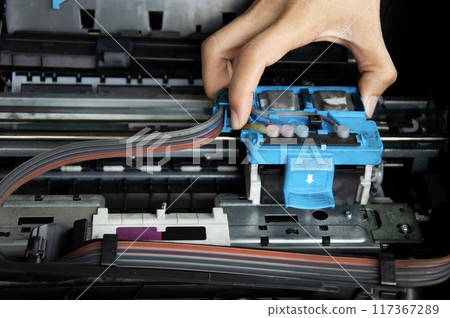 Technician repairing printer, fixing printer head 117367289