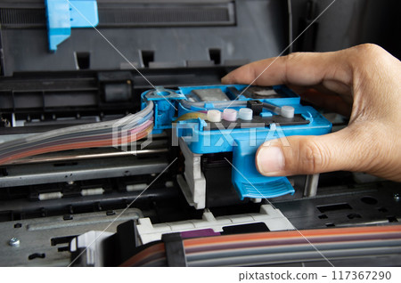 Technician repairing printer, fixing printer head 117367290