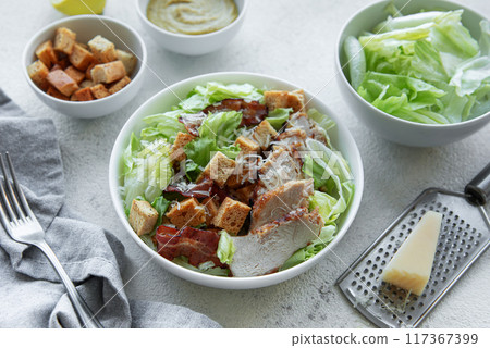 A bowl  of  Caesar salad 117367399