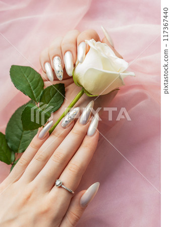 Female Hands with beautiful pearl manicure Female Hands with beautiful pearl manicure 117367440