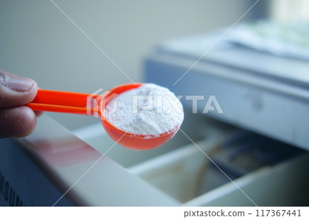 pouring Washing powder in plastic tray of washing machine pouring Washing powder in plastic tray of washing machine 117367441