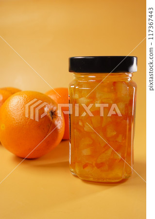 Delicious and Zesty Orange Marmalade Made from Fresh Oranges on a Vibrant Background Delicious and Zesty Orange Marmalade Made from Fresh Oranges on a Vibrant Background 117367443