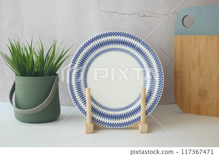 round bowl or ceramic plate on kitchen table. 117367471