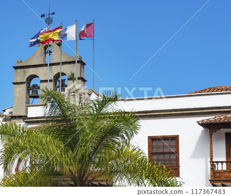 House with bells and flags. On the roof of the house with the bells attached flagpoles with flags House with bells and flags. On the roof of the house with the bells attached flagpoles with flags 117367483