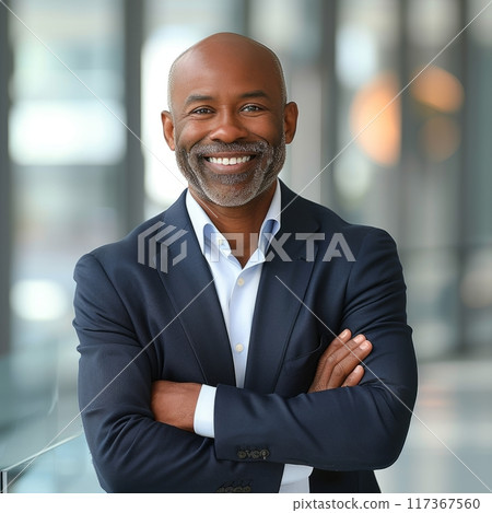 Portrait of an African American male businessman in a suit against the background of an office 117367560