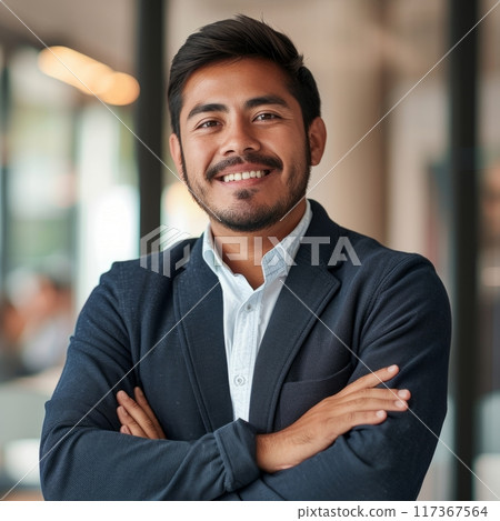 Portrait of a Hispanic male businessman 25-35 years in a suit against the background of an office 117367564
