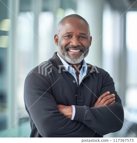 Portrait of an African American male businessman in a suit against the background of an office 117367573