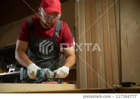 Experienced Carpenter Utilizes Power Tools for Woodworking Project in Workshop Experienced Carpenter Utilizes Power Tools for Woodworking Project in Workshop 117368777
