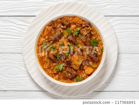beef barley soup in a bowl, top view beef barley soup in a bowl, top view 117368891