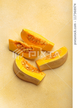 Butternut squash cut in halves lying on kitchen counter Butternut squash cut in halves lying on kitchen counter 117368974