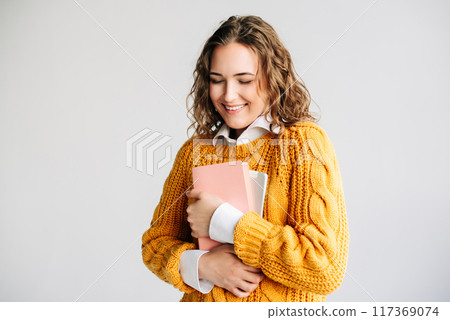 Excited Student with Digital Tablet. Smiling young woman holding a tablet, looking happy and 117369074