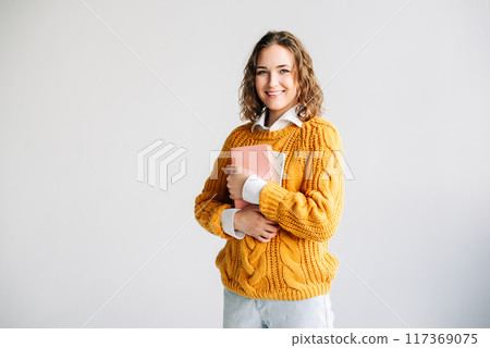 Smiling Woman Holding Digital Tablet. Happy young woman holding a digital tablet, Perfect for themes 117369075