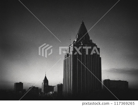 A city skyline with a tall building in the middle 117369265