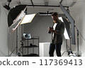 Professional photographer in a studio with specialized equipment for highquality sessions 117369413