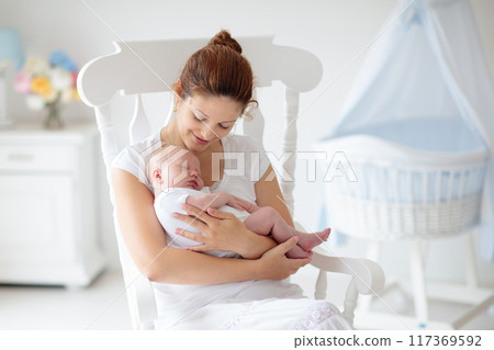 Young mother with newborn baby. 117369592