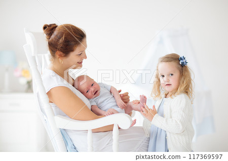 Mother with daughter and baby in a white nursery Mother with daughter and baby in a white nursery 117369597
