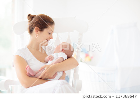 Young mother with newborn baby. 117369647
