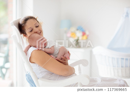 Young mother with newborn baby. 117369665