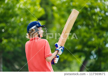 Kids playing cricket in summer park 117369671