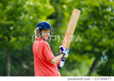 Kids playing cricket in summer park 117369677