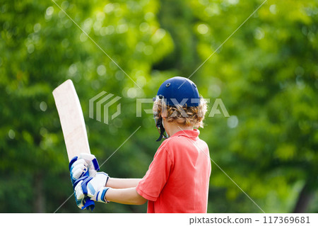Kids playing cricket in summer park Kids playing cricket in summer park 117369681
