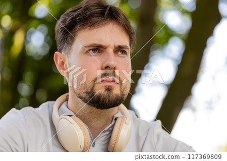 Headphones smartwatch fitness man in park for running, training or marathon, cardio morning routine 117369809